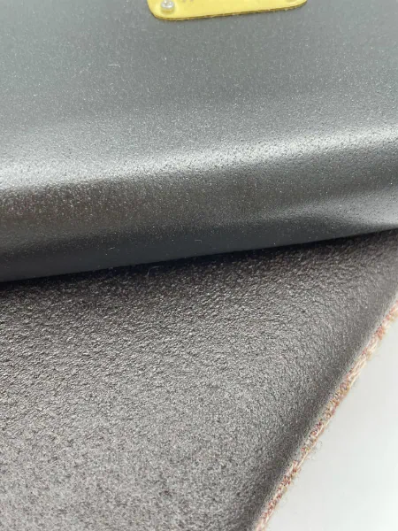 In Vite Veritas collection materials laid flat: Nisiar N-07 and Millésime 2022 grape marc leather