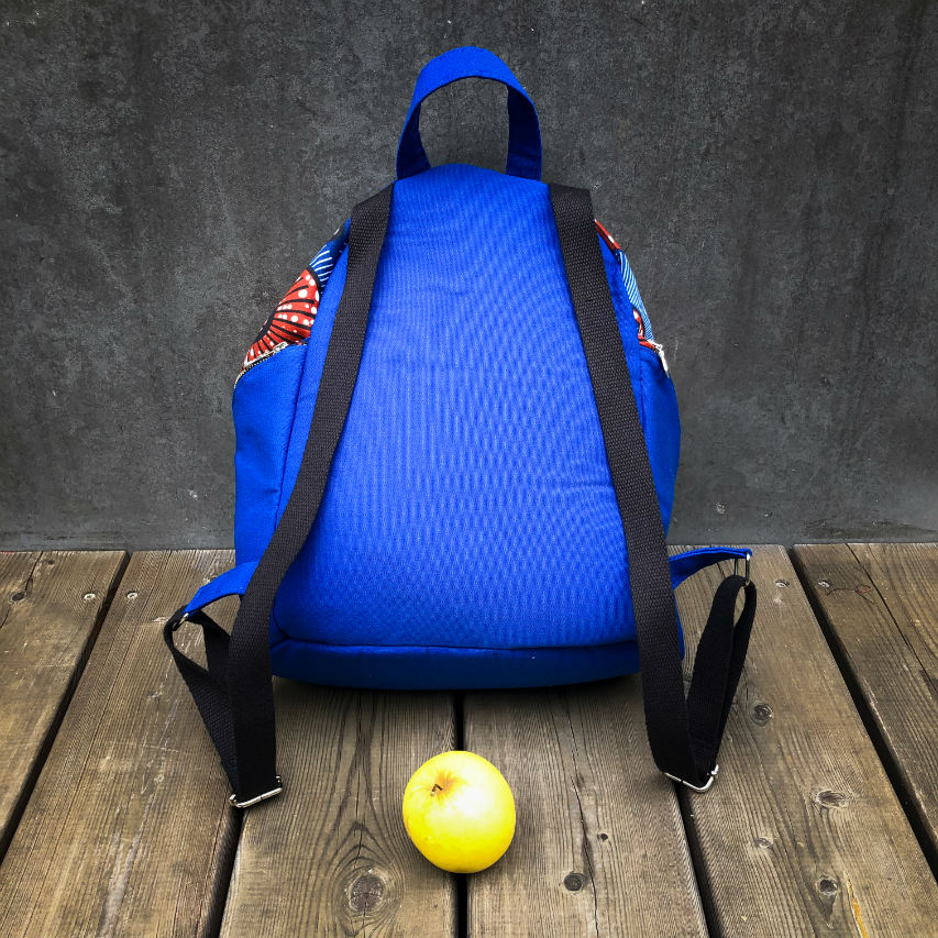 A backpack sewn with royal blue fabric and wax fabric in shades of blue, brown-red, black, and white.