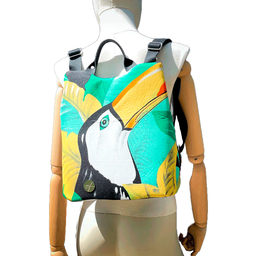 A backpack made of satin black leather, a parrot-patterned neck scarf, and black wool fabric.