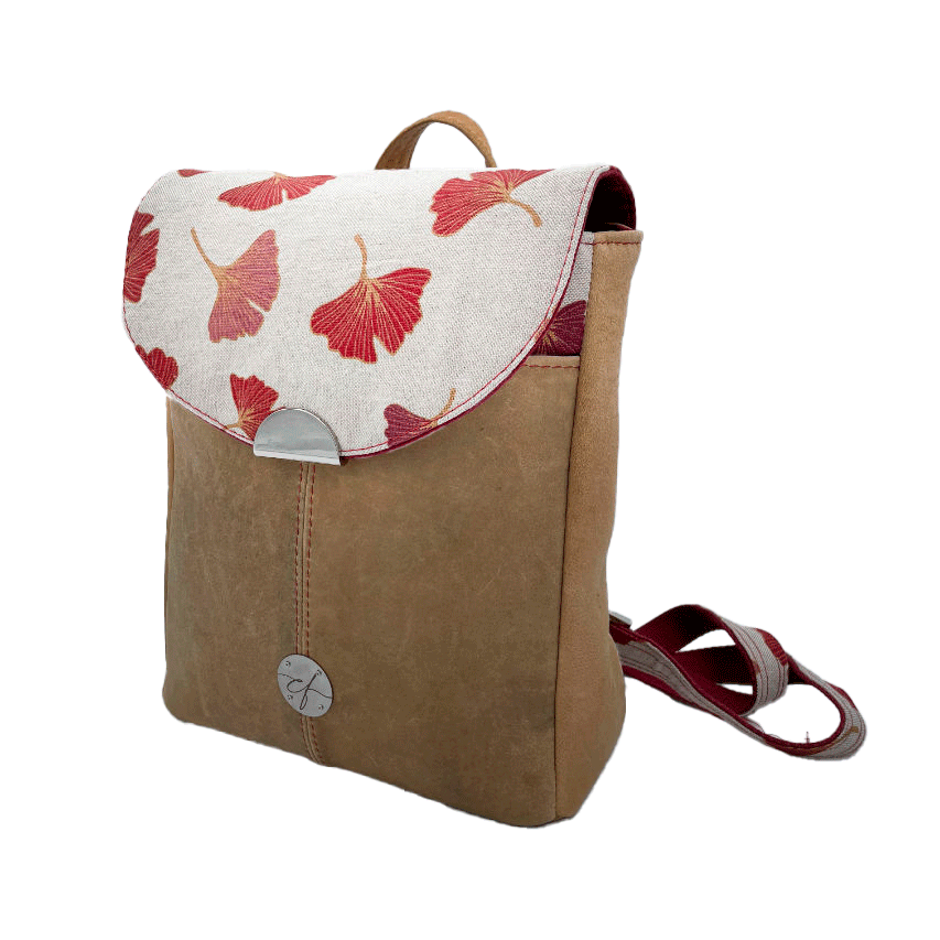 A backpack made from camel colored leather and a red Ginkgo Biloba leaves patterned polycotton canvas.