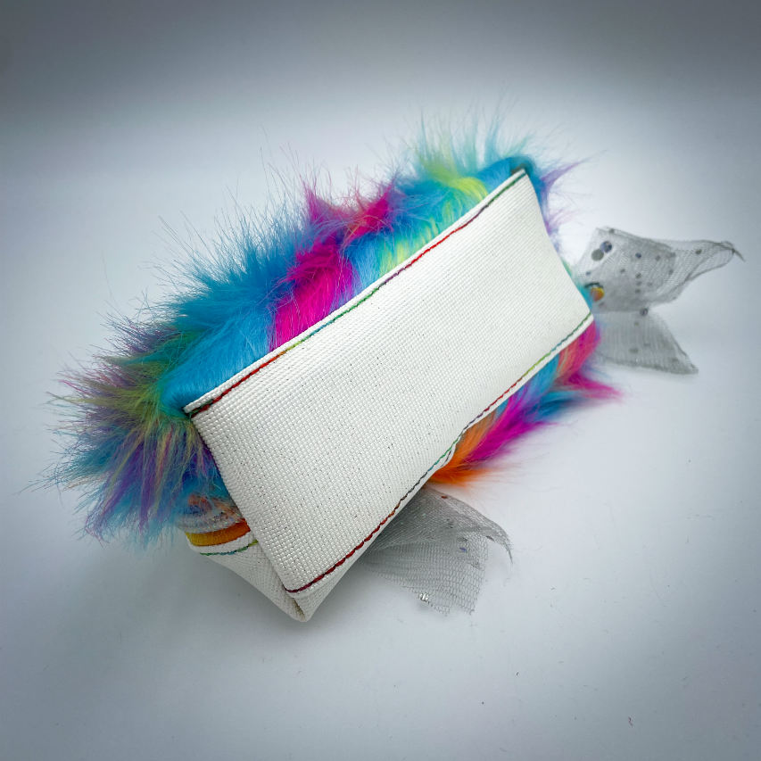 A zippered pouch sewn with white glitter faux leather, rainbow faux fur, and iridescent sequin tulle.