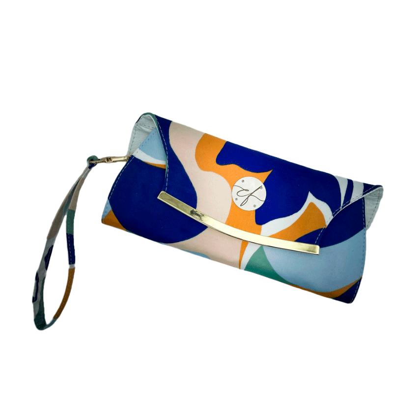 A wallet clutch made from a colorful neck scarf with an abstract and modern flowery design in white, blue, sage, beige and cinammon. Inside are white faux leather and a light sage shiny poplin.