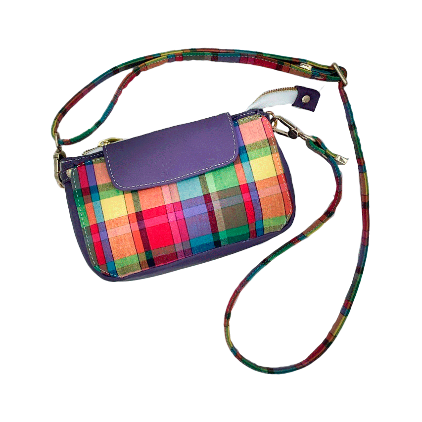 A hybrid clutch wallet bag made of purple leather and multicolored madras fabric.