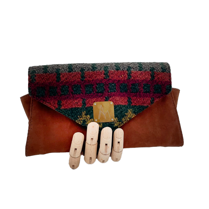 A wallet made from chestnut faux suede and geometric-patterned wool fabric, with a viscose lining featuring a geometric print.