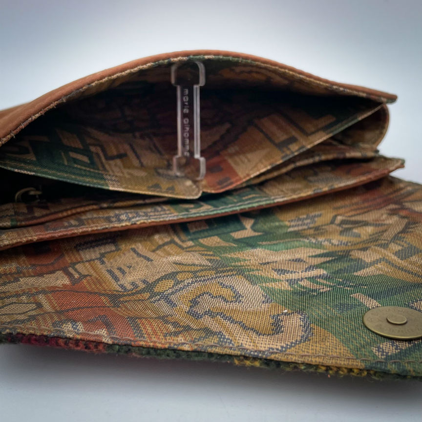 A wallet made from chestnut faux suede and geometric-patterned wool fabric, with a viscose lining featuring a geometric print.