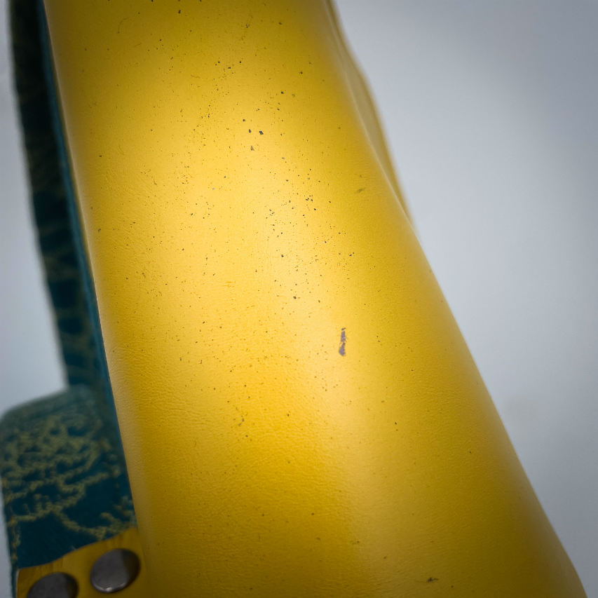 A messenger bag crafted from baby wrap fabric featuring yellow succulents on a turquoise background and sunshine-yellow leather, paired with ice-blue and yellow cotton linings inside.