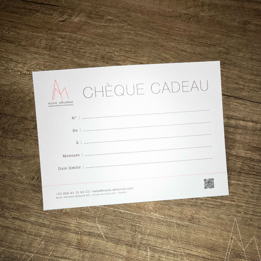 An example gift certificate on a wooden counter.