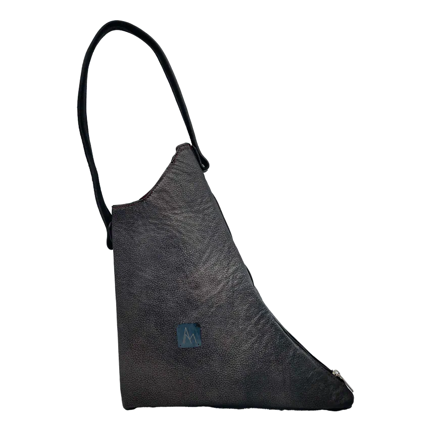 A handbag made of metallic leather with an iridescent red satin lining.