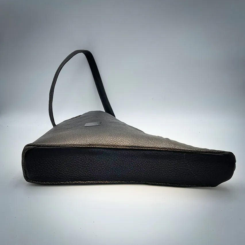 A handbag made of metallic leather with an iridescent red satin lining.