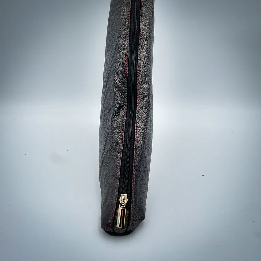 A handbag made of metallic leather with an iridescent red satin lining.