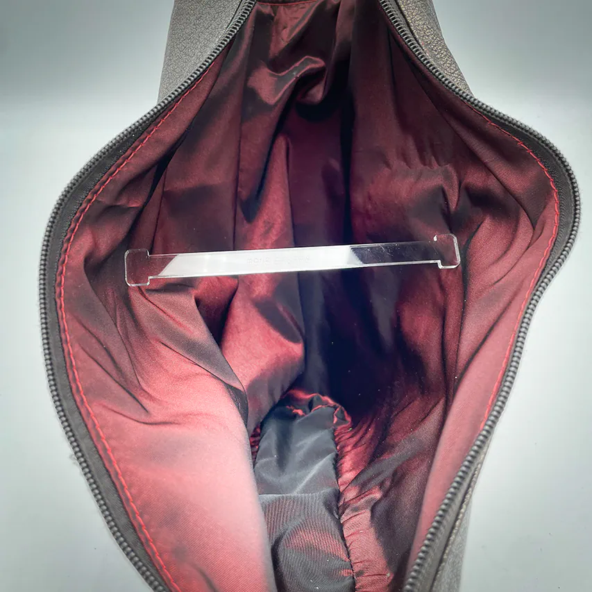 A handbag made of metallic leather with an iridescent red satin lining.