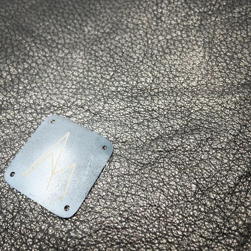 A handbag made of metallic leather with an iridescent red satin lining.
