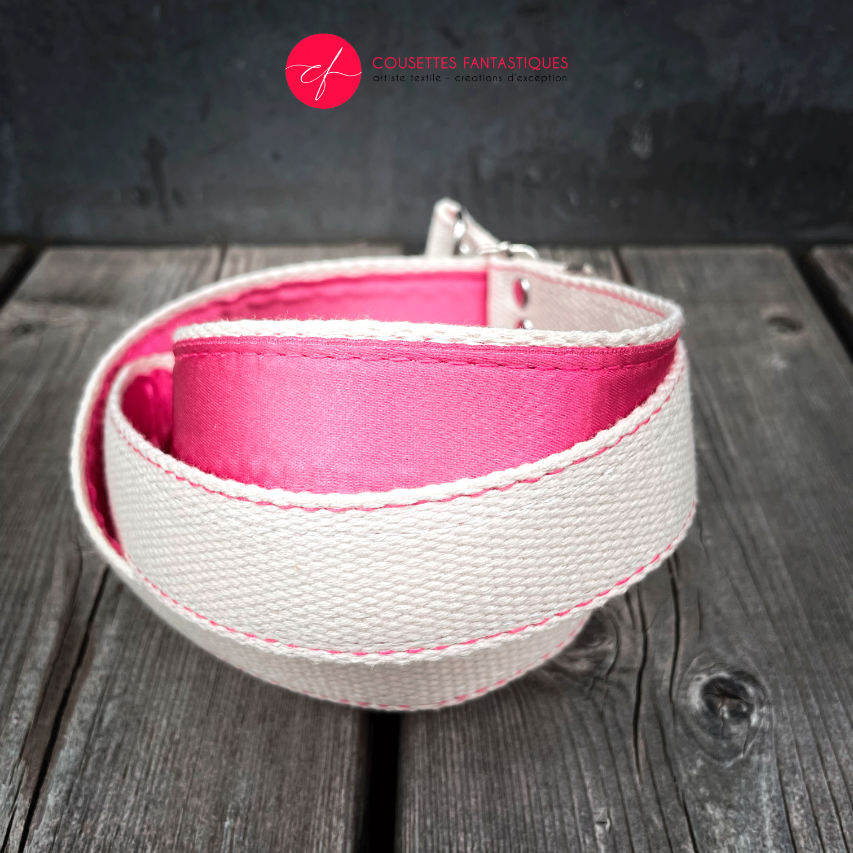 A small handbag made of cream synthetic upholstery fabric with a botanical pattern that fades from pink to orange.