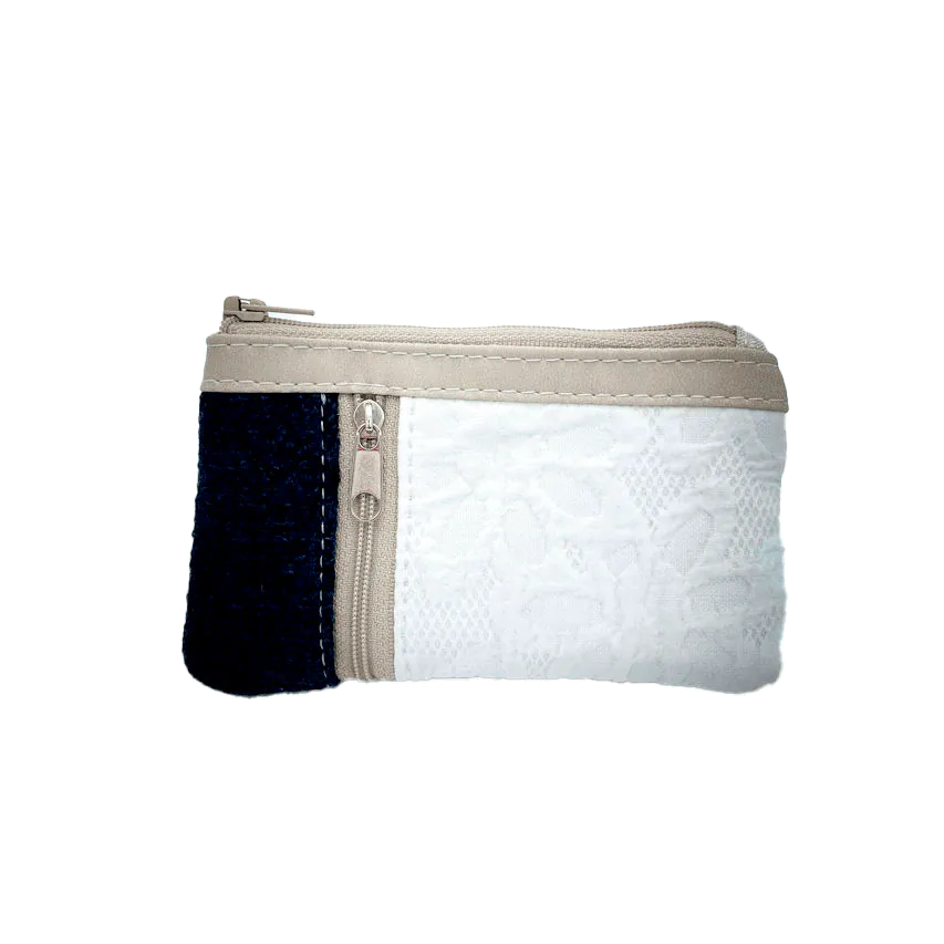 A mini zippered coin purse made from navy blue knitted pullover and white damask fabric.