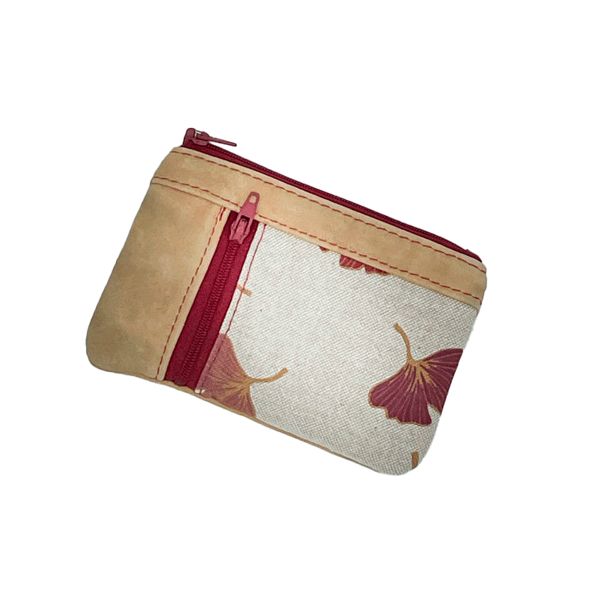 A mini zippered coin purse made of camel colored leather and a red Ginkgo Biloba leaves patterned polycotton canvas.