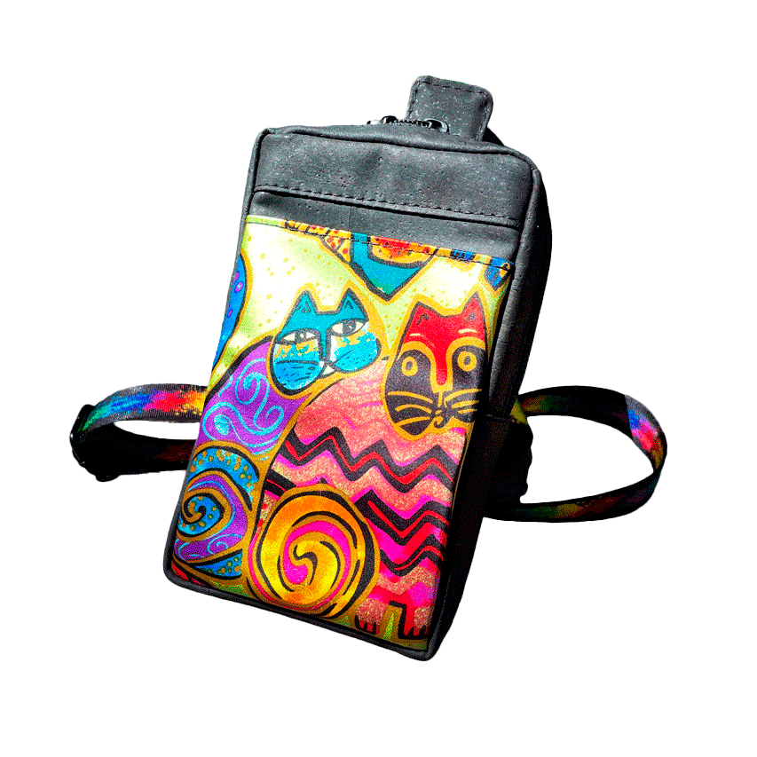 A small backpack made of matte black cork and a silk scarf with a colorful cat pattern, with a black and rainbow adjustable strap.