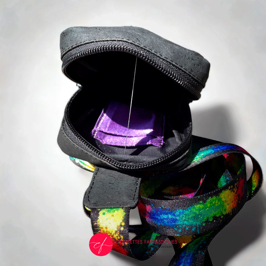 A small backpack made of matte black cork and a silk scarf with a colorful cat pattern, with a black and rainbow adjustable strap.