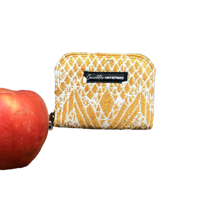 A small zippered card and coin holder made of gray fabric embroidered with blue, red, and white Scandinavian floral patterns.