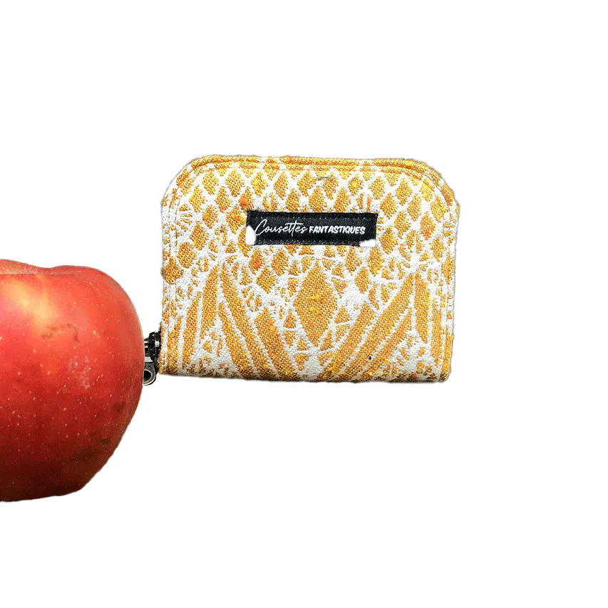 A small zippered card and coin holder made of gray fabric embroidered with blue, red, and white Scandinavian floral patterns.