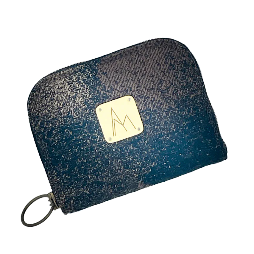 A small zippered card and coin wallet made with black, brown, and beige babywearing fabric featuring an abstract round pattern.
