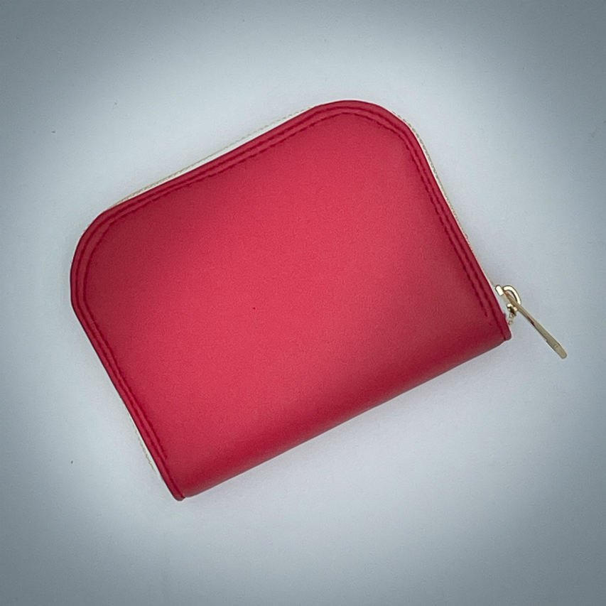 A zipped card-and-coin wallet made from red leather and a red leather printed with white houndstooth, with a red Sonia Rykiel branded lining.