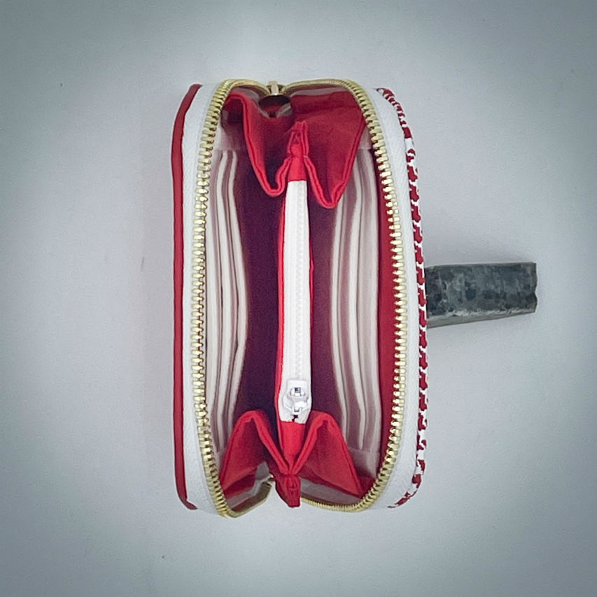 A zipped card-and-coin wallet made from red leather and a red leather printed with white houndstooth, with a red Sonia Rykiel branded lining.