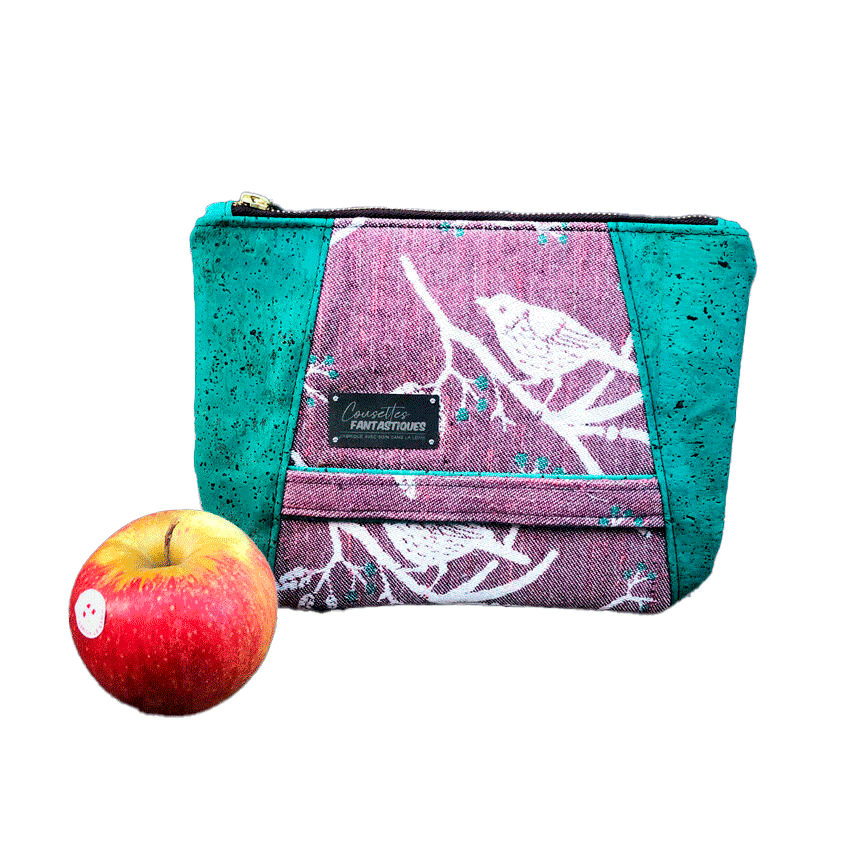 A zippered pouch sewn from a mauve and green babywearing wrap with a bird motif on branches, combined with emerald green cork.