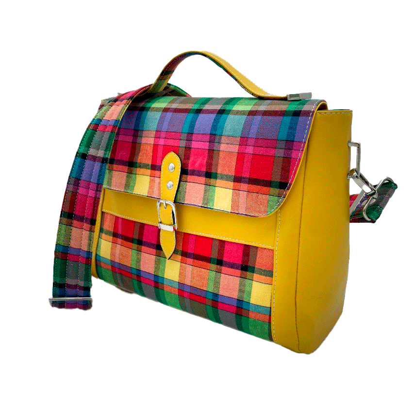 A satchel made of blood-red faux leather and multicolored madras fabric.