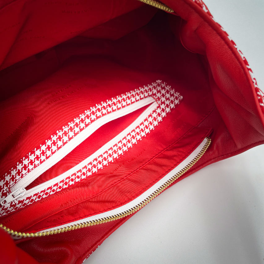 A shoulder bag made from red leather and red leather printed with white houndstooth, with a red Sonia Rykiel branded lining.