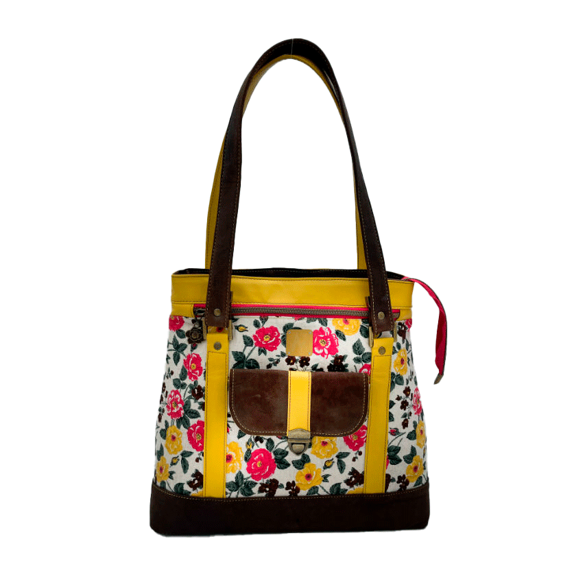 A shoulder bag made from chocolate and yellow leathers combined with a floral canvas featuring pink and yellow flowers.