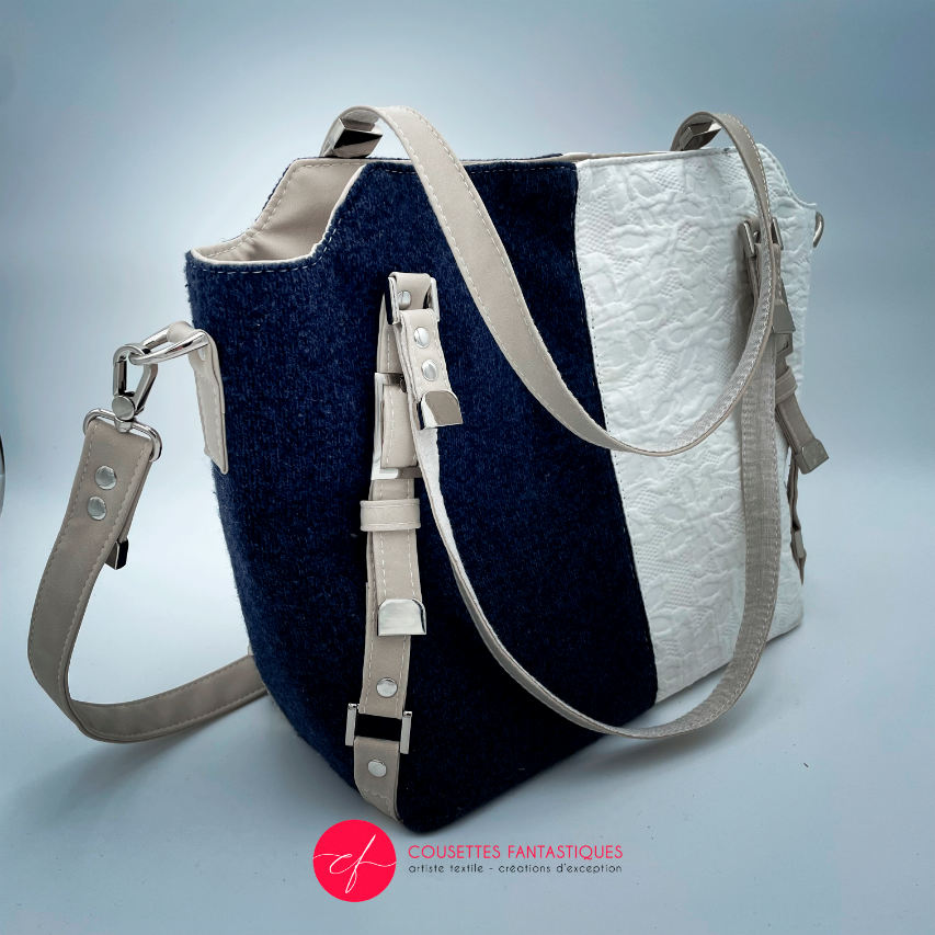 A shoulder bag made from navy wool and white cotton damask.