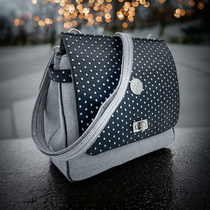 A boxy bag made with a silver dotted black vinyl and grey couture denim.