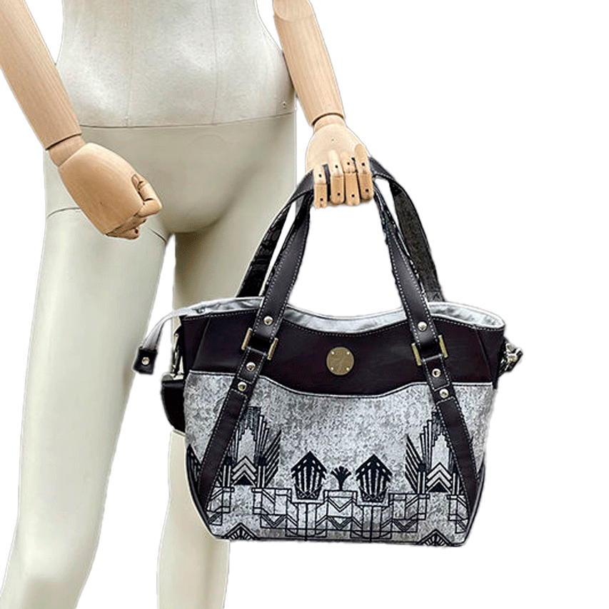 A shoulder bag made with midnight blue and silver geometric Art Deco wrap fabric, and midnight blue leather.