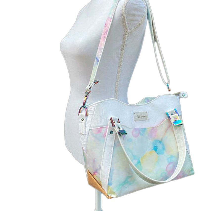 A shoulder bag made from various materials: white synthetic material, hand-painted silk scarf, and white cotton damask.