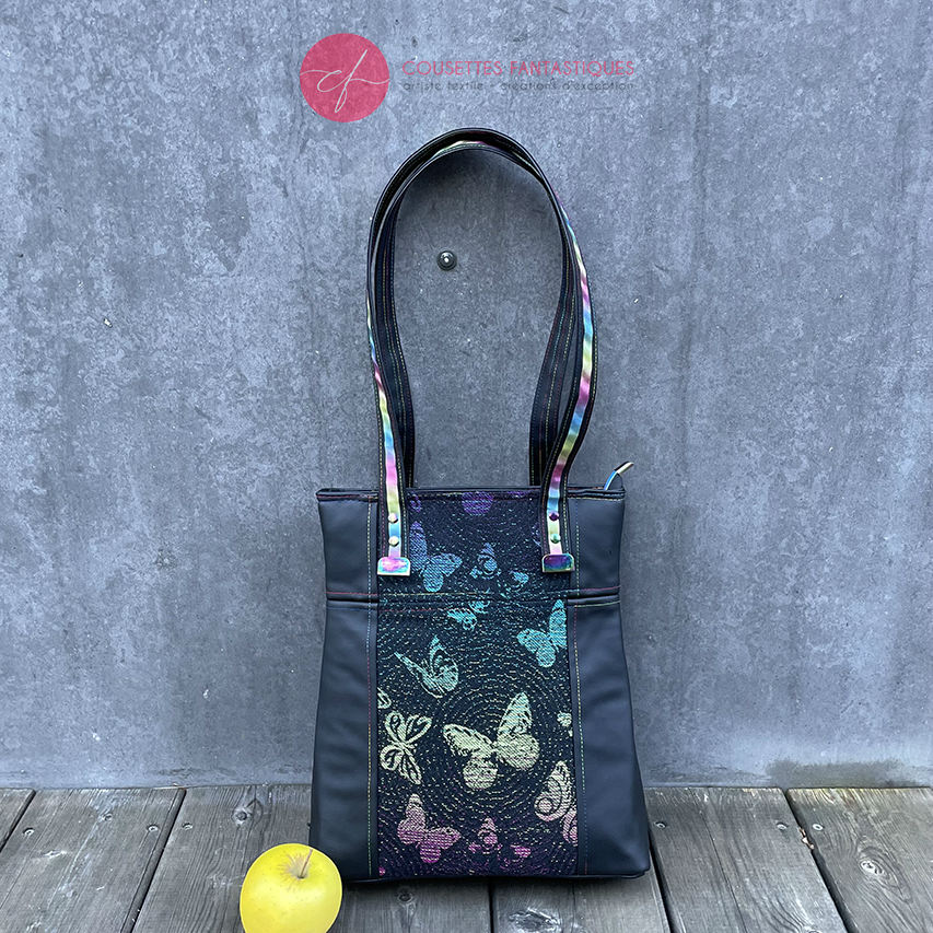 Two-tone/two-material handles, luxury rainbow-colored hardware, velvety upcycled synthetic leather, and a playful babywearing fabric coupon with a whimsical pattern.