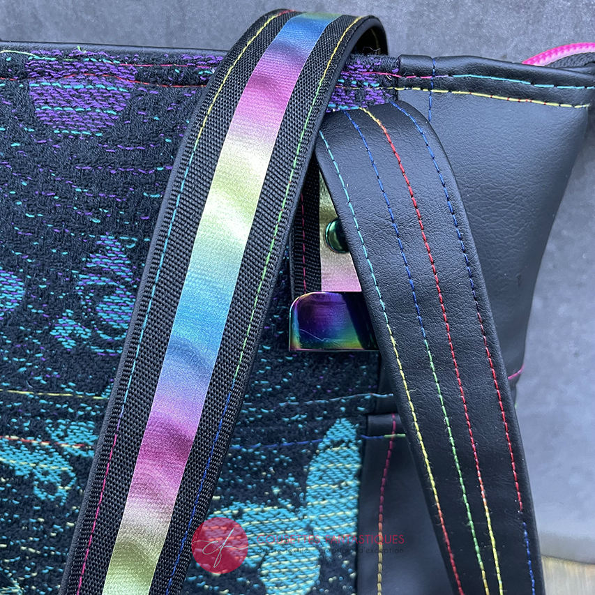 Two-tone/two-material handles, luxury rainbow-colored hardware, velvety upcycled synthetic leather, and a playful babywearing fabric coupon with a whimsical pattern.