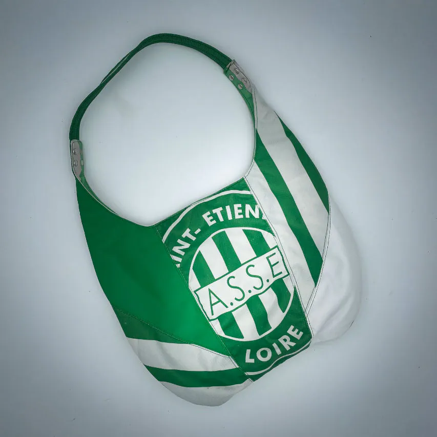 A shoulder bag in white and green leathers combined with a vintage green-and-white football jersey, and a white-and-green polyester satin lining.