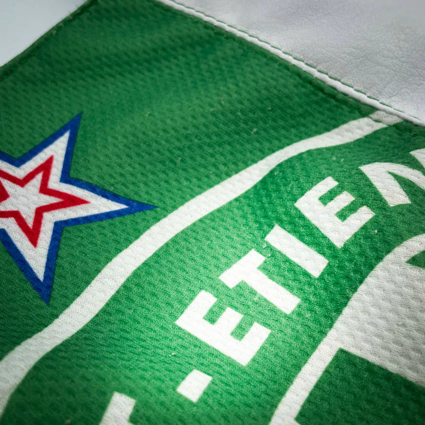 A shoulder bag in white and green leathers combined with a vintage green-and-white football jersey, and a white-and-green polyester satin lining.