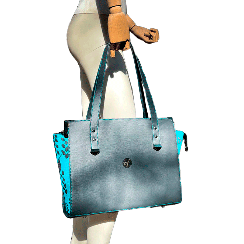 A shoulder bag made of turquoise babywearing fabric with hummingbird and petal motifs, combined with gray and turquoise imitation leather.