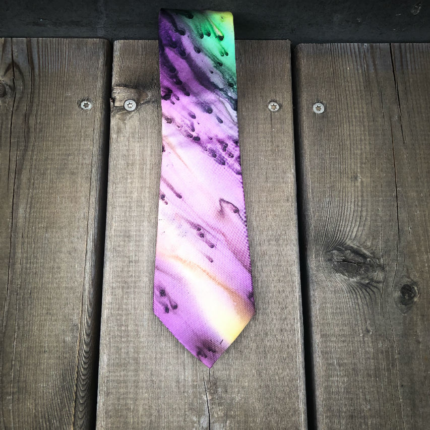 A tie made of blue, green, and purple silk chiffon, lined with taupe ramie.