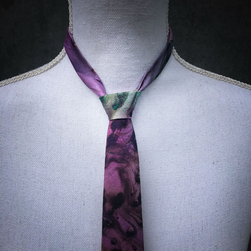 A tie made of blue, green, and purple silk chiffon, lined with taupe ramie.