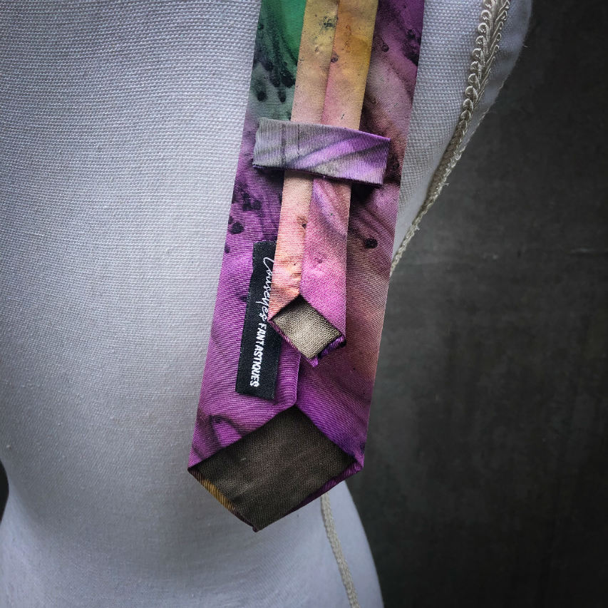 A tie made of blue, green, and purple silk chiffon, lined with taupe ramie.