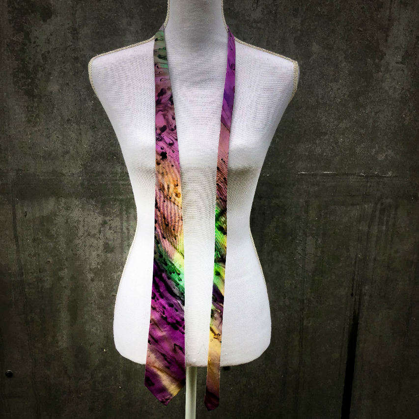 A tie made of blue, green, and purple silk chiffon, lined with taupe ramie.