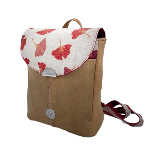 A backpack made from camel colored leather and a red Ginkgo Biloba leaves patterned polycotton canvas.