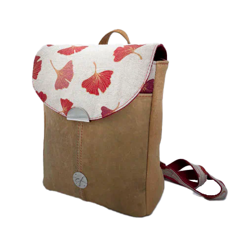 A backpack made from camel colored leather and a red Ginkgo Biloba leaves patterned polycotton canvas.