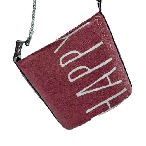 A small “bucket” bag made with delicate pink canvas featuring the word “Happy” and gray ostrich-patterned faux leather.