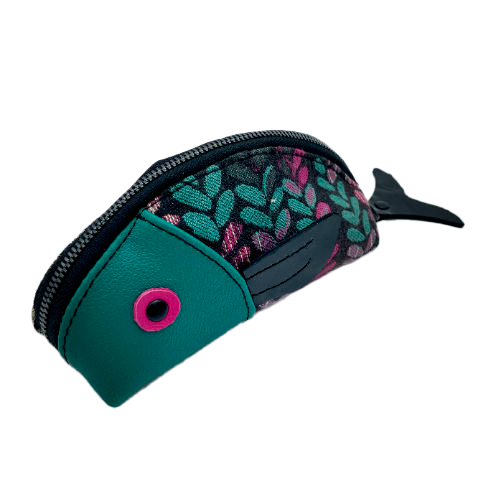A zippered pouch sewn from sage green leather, black patent leather, fuchsia pink leather, and two scraps of a babywearing wrap with a green, beige, and pink mesh pattern on a black background.