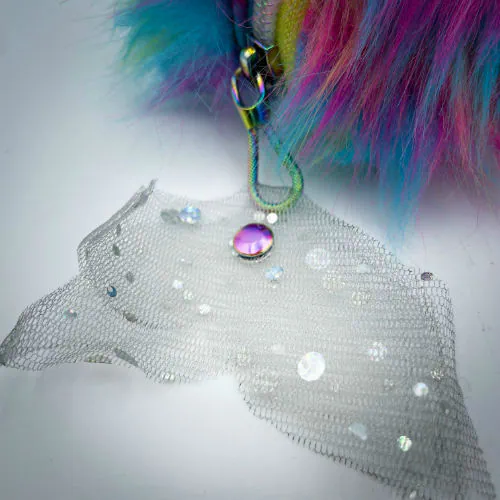 A zippered pouch sewn with white glitter faux leather, rainbow faux fur, and iridescent sequin tulle.