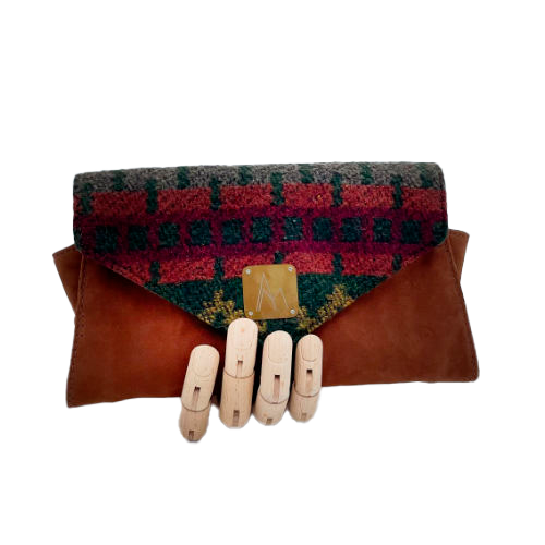 A wallet made from chestnut faux suede and geometric-patterned wool fabric, with a viscose lining featuring a geometric print.