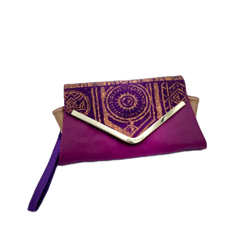 A wallet made from purple and yellow geometrical patterned wrap scrap combined with purple and gold reclaimed faux leathers on the outside, and mustard flax light canvas and deep violet satin on the inside.